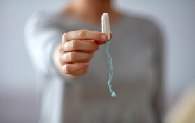 Frau hält Tampon Hygieneartikel fest